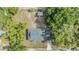 Overhead shot highlighting a home's roof, surrounded by mature trees, and outdoor spaces at 1511 East Emma St. E St, Tampa, FL 33610