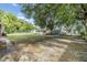 Large backyard with mature trees and a storage shed, offering ample outdoor space at 1511 East Emma St. E St, Tampa, FL 33610