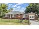Charming brick home with a well-maintained lawn, and a chain-link fence around the yard at 1511 East Emma St. E St, Tampa, FL 33610