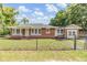 Charming single-story brick home with a fenced yard and well-maintained landscaping at 1511 East Emma St. E St, Tampa, FL 33610