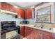 Functional kitchen with stainless sink and range hood and bright natural light at 1511 East Emma St. E St, Tampa, FL 33610