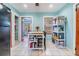 Bright kitchen with blue walls, white tile floors, and casual dining space at 1511 East Emma St. E St, Tampa, FL 33610