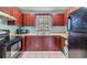 Cozy kitchen featuring wood cabinetry, a window over the sink, and efficient appliances at 1511 East Emma St. E St, Tampa, FL 33610