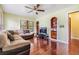 Inviting living room with ceiling fan, hardwood floors and large sectional sofa at 1511 East Emma St. E St, Tampa, FL 33610