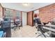 Large home office space with tile floors, brick accent wall, and abundant natural light at 1511 East Emma St. E St, Tampa, FL 33610