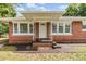 Inviting brick home entrance with decorative columns and a covered porch at 1511 Emma E St, Tampa, FL 33610