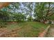 A spacious yard surrounded by lush trees and shrubs creating a private retreat at 1558 Cottonwood Ter, Dunedin, FL 34698