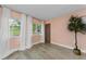 Bright bedroom with large windows, light wood flooring, and neutral accents at 1558 Cottonwood Ter, Dunedin, FL 34698