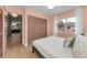Comfortable bedroom with hardwood floors, closet, and large window at 1558 Cottonwood Ter, Dunedin, FL 34698
