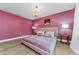 Inviting bedroom featuring light wood floors, a chandelier, and accent lighting at 1558 Cottonwood Ter, Dunedin, FL 34698