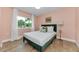 Cozy bedroom with hardwood floors, natural light, and simple decor at 1558 Cottonwood Ter, Dunedin, FL 34698