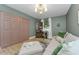 Cozy bedroom featuring soft seating, closet, and hardwood floors at 1558 Cottonwood Ter, Dunedin, FL 34698