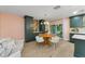 Cozy dining area with stylish furnishings, wood floors, and adjacent to a kitchen at 1558 Cottonwood Ter, Dunedin, FL 34698