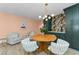 A dining area featuring light wood floors, a round table, and decorative floral wallpaper at 1558 Cottonwood Ter, Dunedin, FL 34698