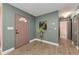 Inviting entryway with stylish decor, a pink front door, and wood-look flooring at 1558 Cottonwood Ter, Dunedin, FL 34698