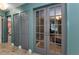 Hallway with grey shaker doors and gray french doors leading to a lounge area at 1558 Cottonwood Ter, Dunedin, FL 34698