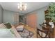 This living room features a pink sofa, decorative area rug, and contemporary light fixture at 1558 Cottonwood Ter, Dunedin, FL 34698