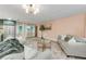 Inviting living room with comfortable seating, neutral color scheme, and natural light at 1558 Cottonwood Ter, Dunedin, FL 34698