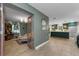 Open-concept living area showcasing hardwood floors and seamless flow to the kitchen at 1558 Cottonwood Ter, Dunedin, FL 34698