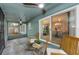 The screened-in porch boasts dual ceiling fans and an outdoor seating area at 1558 Cottonwood Ter, Dunedin, FL 34698