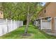 Spacious backyard with mature trees and a well-maintained white fence at 16314 Parkstone Palms Ct, Tampa, FL 33647