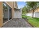 Backyard patio with sliding glass door, brick pavers and well maintained fence at 16314 Parkstone Palms Ct, Tampa, FL 33647