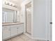 Bright bathroom featuring a single sink vanity and glass enclosed walk-in shower at 16314 Parkstone Palms Ct, Tampa, FL 33647