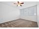 Bright bedroom featuring a ceiling fan, carpet floors and a window allowing for ample natural light at 16314 Parkstone Palms Ct, Tampa, FL 33647
