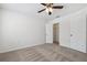Spacious bedroom featuring a ceiling fan, carpet floors and two doors leading to different parts of the house at 16314 Parkstone Palms Ct, Tampa, FL 33647