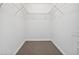 Walk-in closet with carpet floors, white walls and wire shelving for organized storage at 16314 Parkstone Palms Ct, Tampa, FL 33647