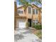 Charming townhome with a one-car garage, well-maintained landscaping, and inviting front entrance at 16314 Parkstone Palms Ct, Tampa, FL 33647