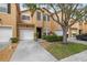 Charming townhome with a one-car garage, well-maintained landscaping, and inviting front entrance at 16314 Parkstone Palms Ct, Tampa, FL 33647
