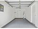 Clean, spacious one-car garage featuring an epoxy floor and convenient interior access at 16314 Parkstone Palms Ct, Tampa, FL 33647