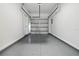 Clean, spacious one-car garage featuring an epoxy floor and convenient interior access at 16314 Parkstone Palms Ct, Tampa, FL 33647
