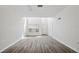 Bright living room with hardwood-style flooring, neutral paint, and ample natural light at 16314 Parkstone Palms Ct, Tampa, FL 33647