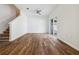 Spacious living room with wood-look floors, a ceiling fan and sliding glass door leading to the outside at 16314 Parkstone Palms Ct, Tampa, FL 33647