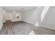 Bright living room with hardwood-style flooring, neutral paint, and ample natural light at 16314 Parkstone Palms Ct, Tampa, FL 33647