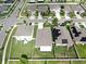 Aerial view showcasing the neighborhood with well-maintained lawns and solar panels at 17136 Sunshine Mimosa: St, Wimauma, FL 33598