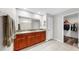 Bathroom features double vanity with granite top and walk-in closet access at 17136 Sunshine Mimosa: St, Wimauma, FL 33598