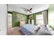 Bright bedroom with blue quilt, ceiling fan, and floating bookshelves at 17136 Sunshine Mimosa: St, Wimauma, FL 33598