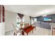 Dining area featuring a wooden table, bench seating, and windows offering natural light to the dining and living areas at 17136 Sunshine Mimosa: St, Wimauma, FL 33598