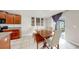 View of dining room with wood table, bench seating, and access to the outdoor patio through sliding glass doors at 17136 Sunshine Mimosa: St, Wimauma, FL 33598