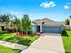 Charming single-story home with a well-maintained lawn, mature trees, and attached two-car garage at 17136 Sunshine Mimosa: St, Wimauma, FL 33598