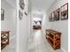Inviting hallway with tile flooring, decorative wall art, and a glimpse of the cozy living room at the end at 17136 Sunshine Mimosa: St, Wimauma, FL 33598
