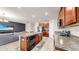Modern kitchen with granite countertops, stainless steel appliances, island and an open view to the living room at 17136 Sunshine Mimosa: St, Wimauma, FL 33598