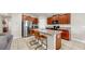 Well-equipped kitchen with granite countertops, stainless steel appliances, ample cabinetry, and a breakfast bar with seating at 17136 Sunshine Mimosa: St, Wimauma, FL 33598