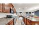 Spacious kitchen with granite countertops, stainless steel appliances, and views into the dining and living areas at 17136 Sunshine Mimosa: St, Wimauma, FL 33598