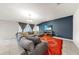 Comfortable living room with a plush sectional sofa, media console, and a bright window with natural light at 17136 Sunshine Mimosa: St, Wimauma, FL 33598