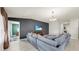 Comfortable living room with a plush sectional sofa, media console, and a bright window with natural light at 17136 Sunshine Mimosa: St, Wimauma, FL 33598