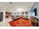 Spacious living room featuring a large sectional sofa, open layout, and view into the modern kitchen at 17136 Sunshine Mimosa: St, Wimauma, FL 33598